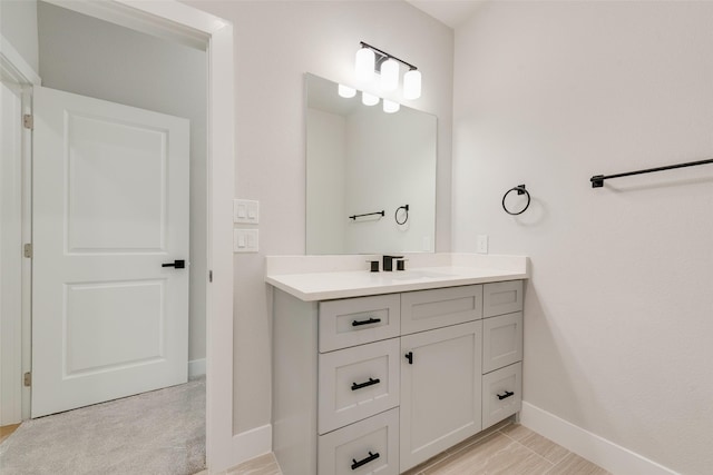 bathroom featuring baseboards and vanity