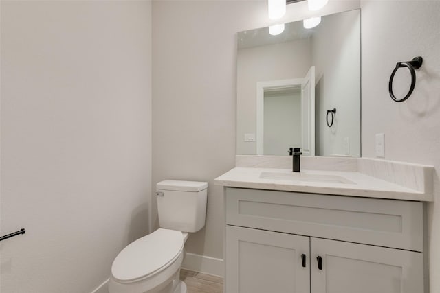 6810 Windward View Dr, Rowlett, TX 75088 - bathroom featuring toilet, vanity, baseboards, and wood finished floors