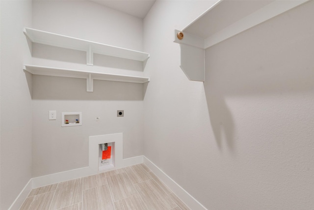 laundry area featuring electric dryer hookup, hookup for a washing machine, baseboards, and gas dryer hookup