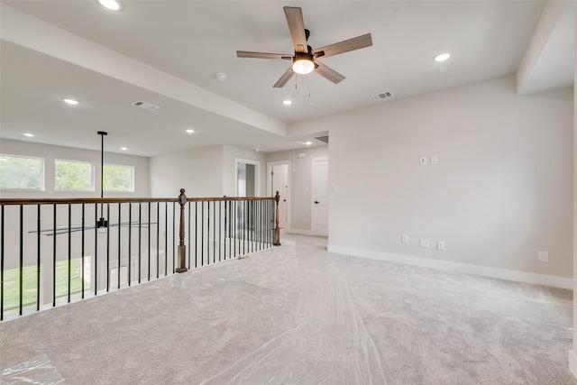 carpeted spare room with a ceiling fan, recessed lighting, and visible vents