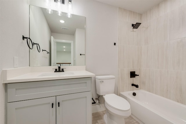 bathroom featuring vanity, washtub / shower combination, toilet, and visible vents