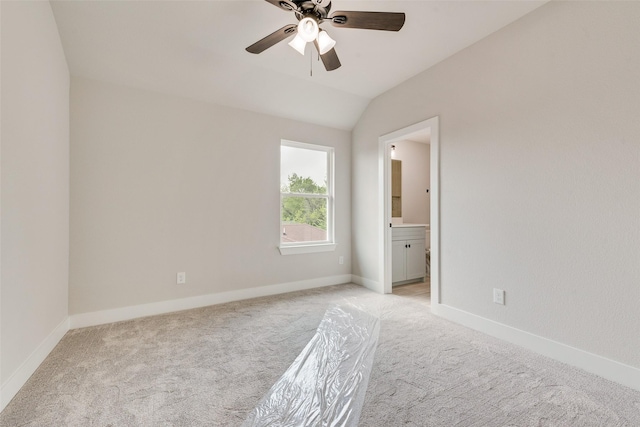6810 Windward View Dr, Rowlett, TX 75088 - spare room featuring light carpet, ceiling fan, vaulted ceiling, and baseboards