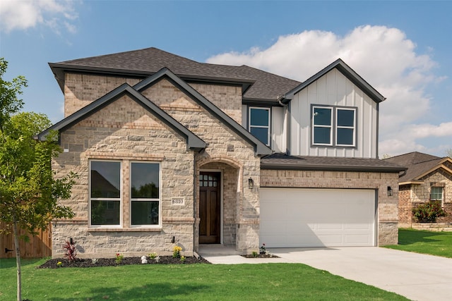 view of front facade featuring a garage, board and batten siding, driveway, and a front yard