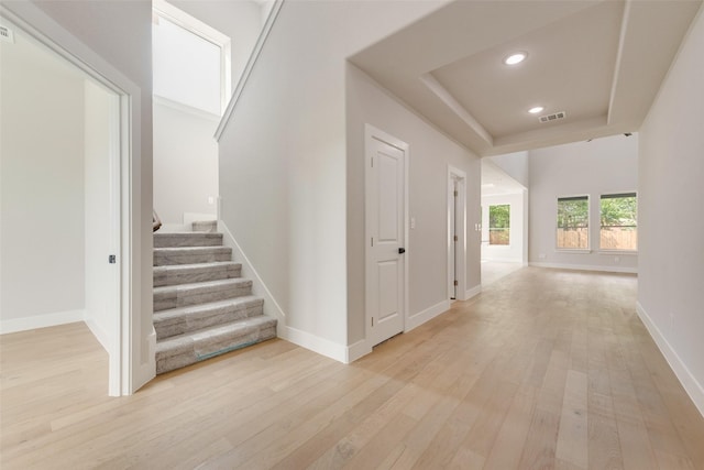 6810 Windward View Dr, Rowlett, TX 75088 - hallway featuring light wood-style floors, stairway, a raised ceiling, recessed lighting, and baseboards