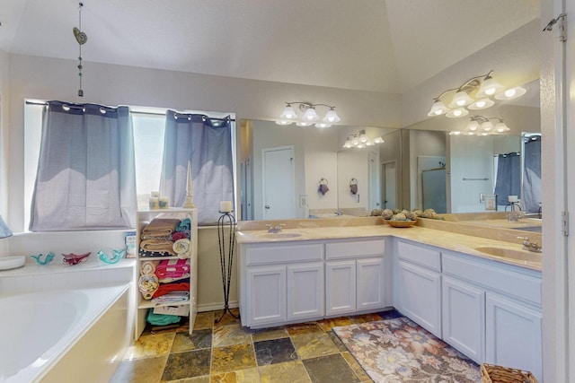 231 Dove Hill Ln, Weatherford, TX 76088 - full bath featuring stone finish floor, a bath, double vanity, and a sink