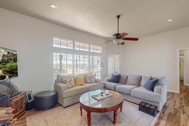 231 Dove Hill Ln, Weatherford, TX 76088 - living room with recessed lighting, light wood-style floors, a high ceiling, and ceiling fan
