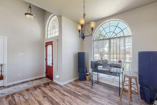 231 Dove Hill Ln, Weatherford, TX 76088 - foyer entrance with an inviting chandelier, a healthy amount of sunlight, and wood finished floors