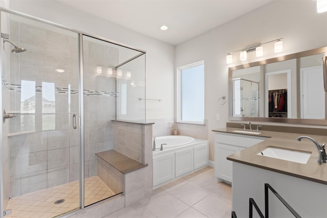full bathroom featuring a bath, vanity, tile patterned flooring, and a stall shower