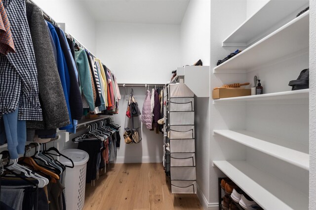 walk in closet featuring light wood-style flooring