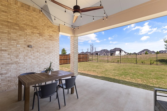 view of patio with outdoor dining area, a residential view, a ceiling fan, and a fenced backyard