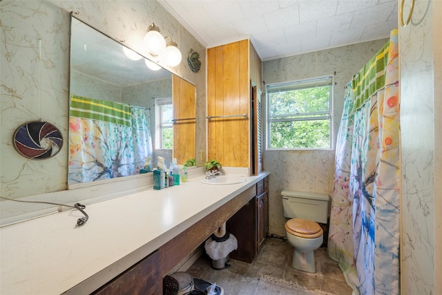 bathroom with a shower with shower curtain, toilet, and vanity