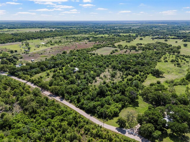 drone / aerial view featuring a wooded view