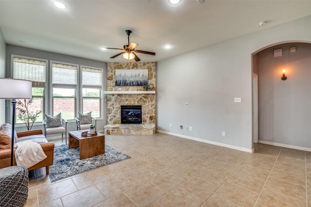 5220 Grove Cove Dr, Mckinney, TX 75071 - living room with arched walkways, baseboards, recessed lighting, a ceiling fan, and a fireplace