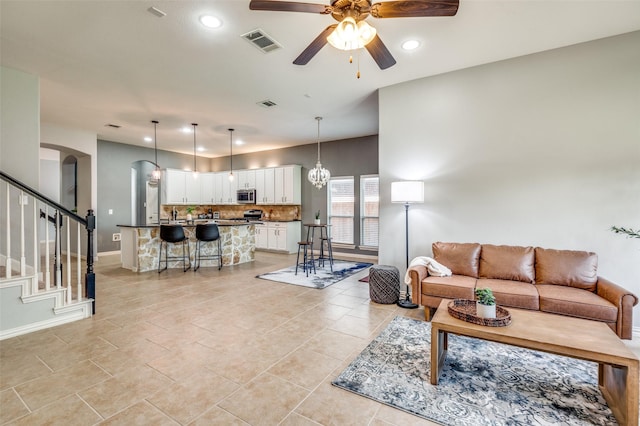 5220 Grove Cove Dr, Mckinney, TX 75071 - living room featuring a ceiling fan, visible vents, arched walkways, and recessed lighting