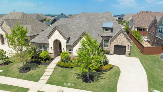 996 Heather Falls Dr, Rockwall, TX 75087 - french country home with concrete driveway, stone siding, a garage, brick siding, and a residential view