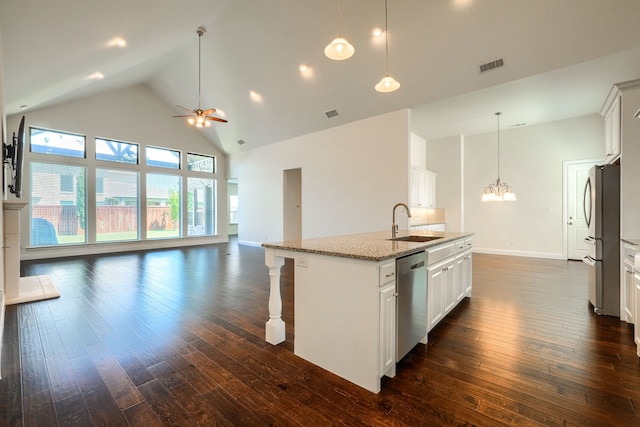 996 Heather Falls Dr, Rockwall, TX 75087 - kitchen with a sink, stainless steel appliances, high vaulted ceiling, dark wood-type flooring, and a chandelier