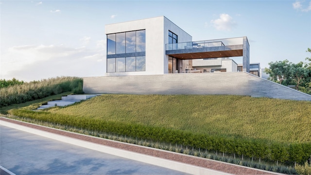 view of front of property with a front lawn, a balcony, and stucco siding