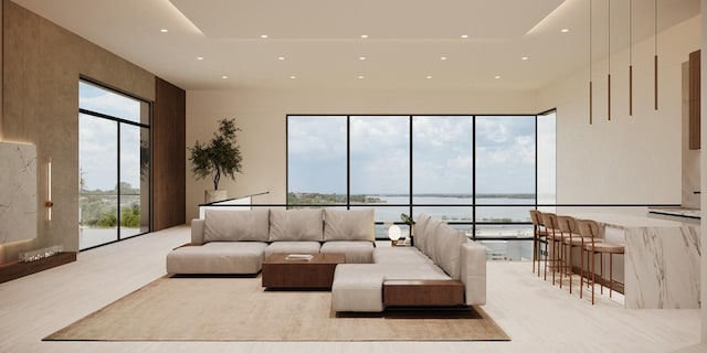 living area with recessed lighting, plenty of natural light, and a water view
