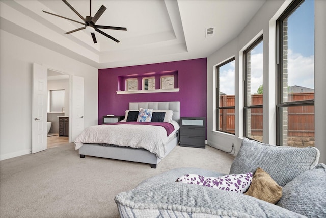 9300 Pecan Woods Trl, Argyle, TX 76226 - bedroom with a tray ceiling, carpet flooring, baseboards, ensuite bathroom, and ceiling fan