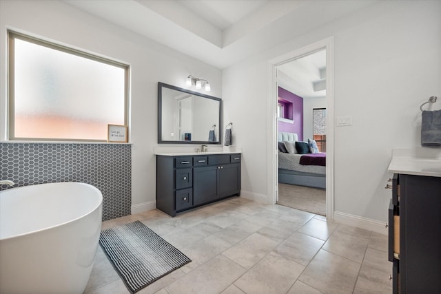 9300 Pecan Woods Trl, Argyle, TX 76226 - ensuite bathroom with vanity, a freestanding bath, and baseboards