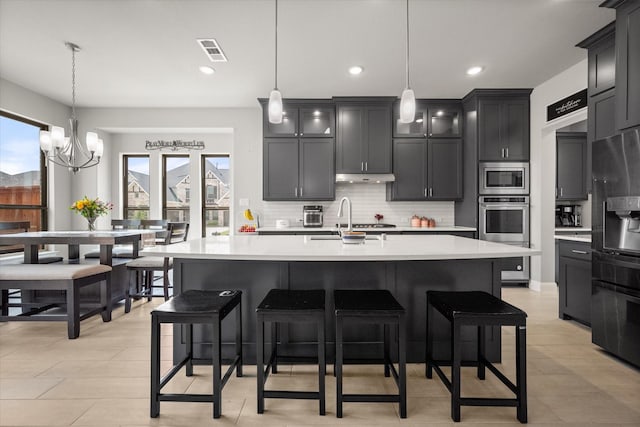 9300 Pecan Woods Trl, Argyle, TX 76226 - kitchen with a sink, appliances with stainless steel finishes, light countertops, decorative backsplash, and under cabinet range hood