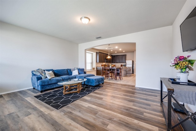3412 San Lucas Ln, Denton, TX 76208 - living area featuring arched walkways, wood finished floors, and baseboards