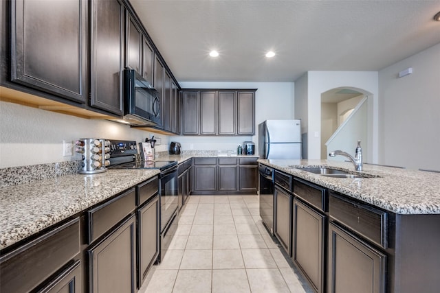 3412 San Lucas Ln, Denton, TX 76208 - kitchen with black appliances, a sink, light stone countertops, light tile patterned floors, and recessed lighting