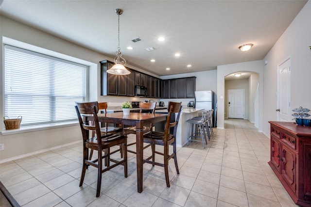 3412 San Lucas Ln, Denton, TX 76208 - dining space with arched walkways, baseboards, light tile patterned floors, and recessed lighting