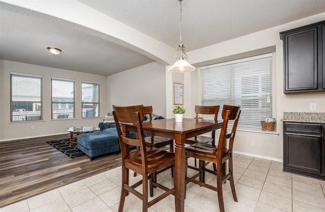3412 San Lucas Ln, Denton, TX 76208 - dining room with light tile patterned flooring, baseboards, and arched walkways