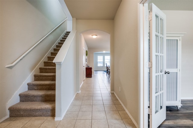 3412 San Lucas Ln, Denton, TX 76208 - stairs featuring arched walkways, tile patterned flooring, and baseboards