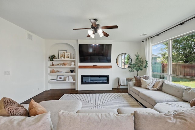 1308 Kittyhawk Dr, Little Elm, TX 75068 - living room featuring ceiling fan, wood finished floors, a glass covered fireplace, and baseboards