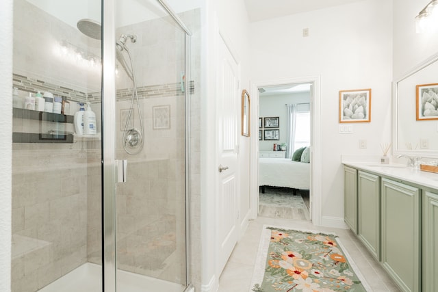 ensuite bathroom featuring a shower stall, connected bathroom, tile patterned floors, and vanity