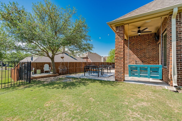 view of yard featuring fence, a ceiling fan, and a patio