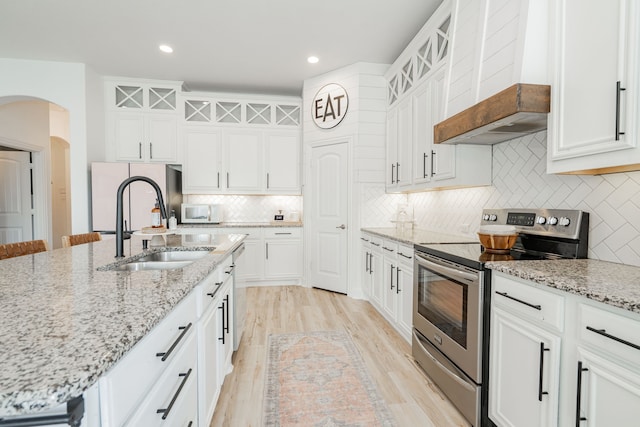 kitchen with white cabinetry, stainless steel appliances, and a sink