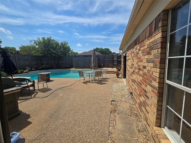 view of swimming pool featuring a fenced backyard, a fenced in pool, and a patio area