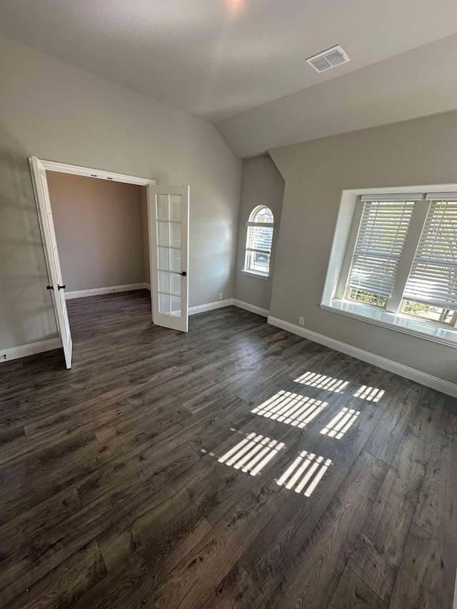1217 Timber Grove Ter, Little Elm, TX 76227 - unfurnished bedroom with baseboards, vaulted ceiling, visible vents, and dark wood-style floors