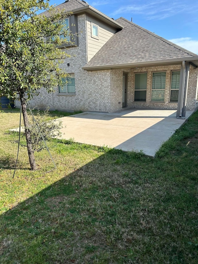 1217 Timber Grove Ter, Little Elm, TX 76227 - back of property with a yard, a shingled roof, and a patio