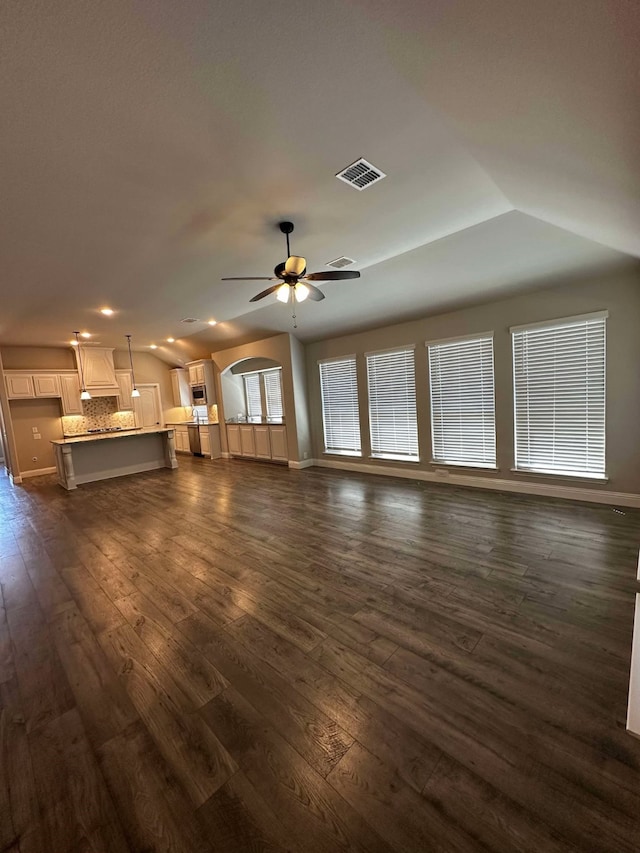 1217 Timber Grove Ter, Little Elm, TX 76227 - unfurnished living room with ceiling fan, baseboards, dark wood finished floors, lofted ceiling, and visible vents