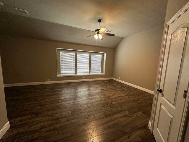 1217 Timber Grove Ter, Little Elm, TX 76227 - unfurnished bedroom featuring a ceiling fan, baseboards, lofted ceiling, dark wood-type flooring, and visible vents