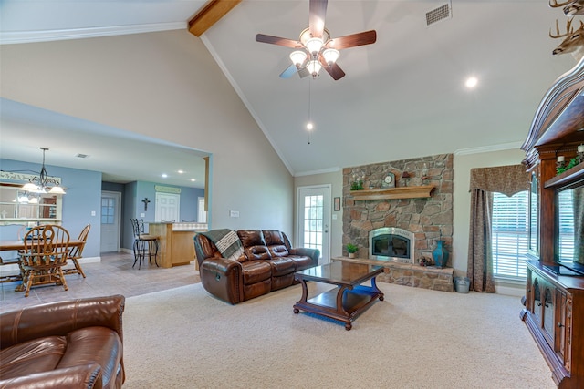 living area featuring ceiling fan, visible vents, a fireplace, beamed ceiling, and carpet flooring