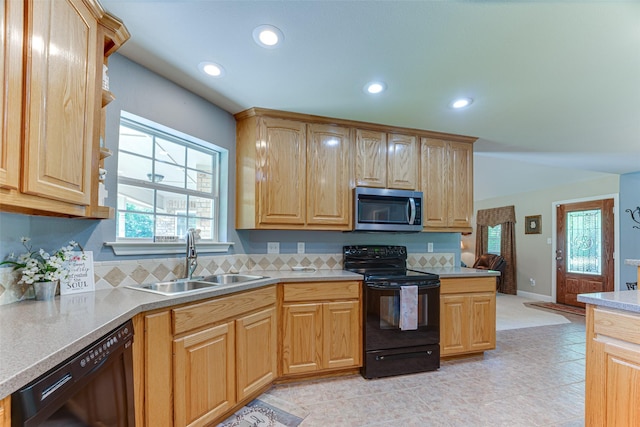kitchen with light brown cabinets, recessed lighting, light countertops, a sink, and black appliances