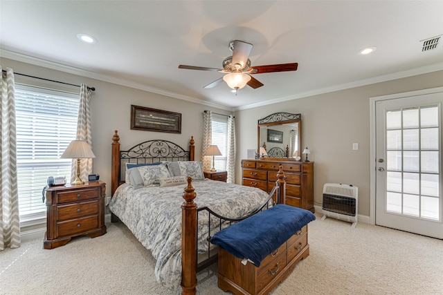 bedroom featuring visible vents, heating unit, crown molding, and light colored carpet
