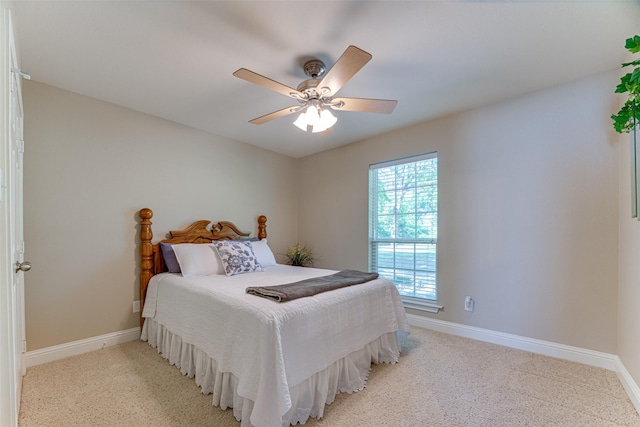 bedroom with baseboards, ceiling fan, and light colored carpet