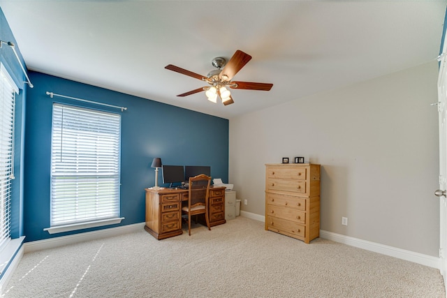 office space featuring carpet floors, ceiling fan, and baseboards