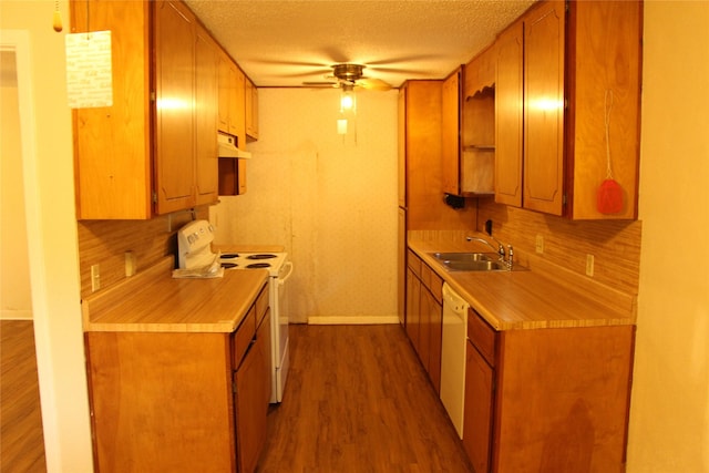 611 E 8th St, Cisco, TX 76437 - kitchen with a sink, baseboards, white appliances, ceiling fan, and under cabinet range hood