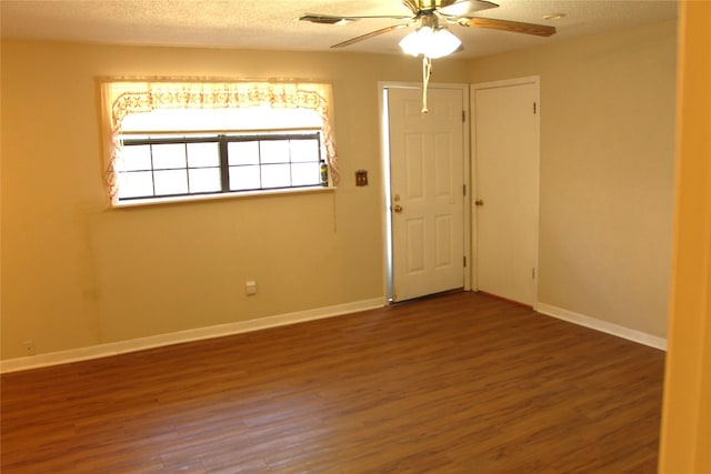 611 E 8th St, Cisco, TX 76437 - empty room with a ceiling fan, wood finished floors, a textured ceiling, baseboards, and visible vents