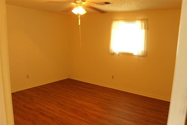 611 E 8th St, Cisco, TX 76437 - empty room featuring dark wood finished floors, baseboards, a ceiling fan, and a textured ceiling