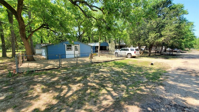 7143 Pakuna Dr, Mabank, TX 75156 - living area featuring a ceiling fan, wood finished floors, stairs, baseboards, and a wall unit AC