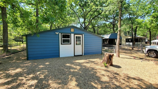 view of outbuilding with an outdoor structure and fence
