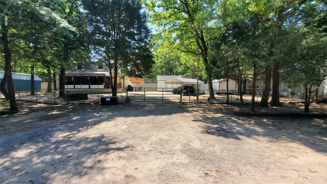 view of yard with fence and an outbuilding
